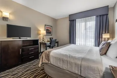 a hotel room with a bed and a flat screen tv at Best Western Plus Hotel at the Convention Center in Long Beach