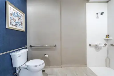 a bathroom with a toilet and a shower at Best Western Plus Hotel at the Convention Center in Long Beach
