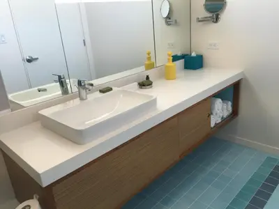 a bathroom with a white sink and a mirror at The Beverly Laurel Hotel at West Hollywood in Los Angeles