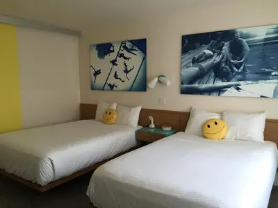 a hotel room with two beds with smileys on them at The Beverly Laurel Hotel at West Hollywood in Los Angeles