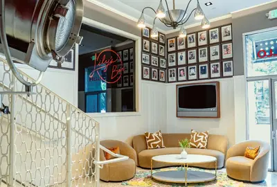 a living room with a couch and a table at The Hollywood Franklin Hotel near Universal Studios in Los Angeles