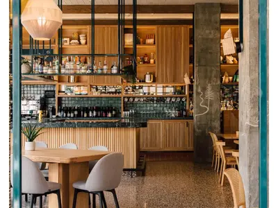 a restaurant with tables and chairs and a bar at Hotel June West LA, a Member of Design Hotels in Los Angeles
