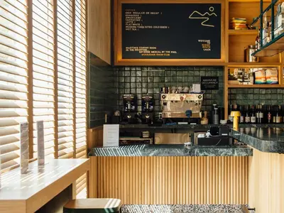 a restaurant with a counter with a coffee bar at Hotel June West LA, a Member of Design Hotels in Los Angeles