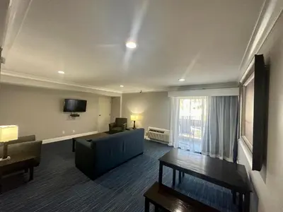 a living room with a couch and a window at The Pacific Inn in Seal Beach