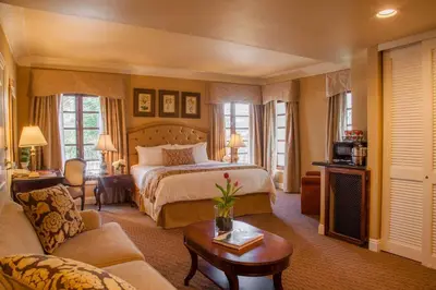 a hotel room with a bed and a couch at Best Western Plus Sunset Plaza Hotel in Los Angeles