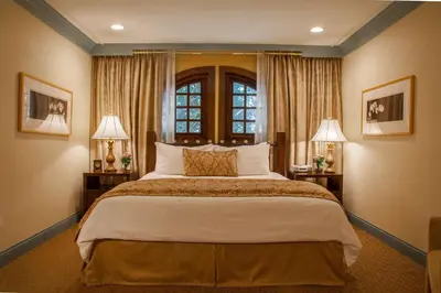 a bedroom with a large bed and two lamps at Best Western Plus Sunset Plaza Hotel in Los Angeles