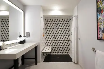 a bathroom with a shower with a sink and a toilet at Montrose at Beverly Hills in Los Angeles