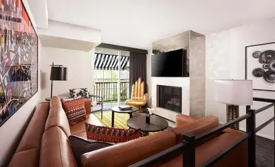 a living room with a couch and a fireplace at Montrose at Beverly Hills in Los Angeles