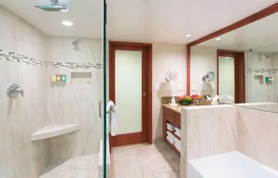 a bathroom with a shower and a sink at Coast Burbank Hotel in Burbank