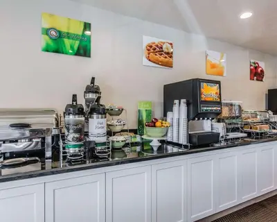 a buffet with food and drinks on a counter at Quality Inn Rosemead-Los Angeles in Rosemead