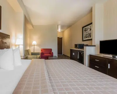a hotel room with a bed and a flat screen tv at Quality Inn Rosemead-Los Angeles in Rosemead