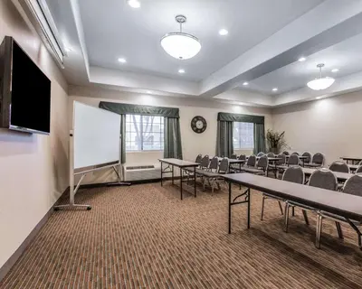 a conference room with tables and chairs and a whiteboard at Quality Inn Rosemead-Los Angeles in Rosemead