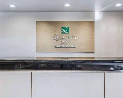 a sign for a quality inn on a wall at Quality Inn Rosemead-Los Angeles in Rosemead