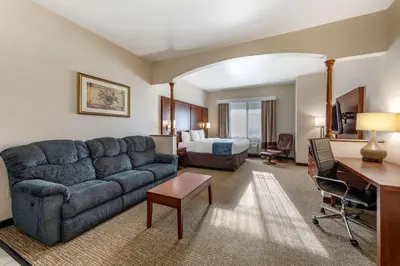 a hotel room with a couch and a bed at Citrus Suites Redlands Loma Linda Hotel in Redlands