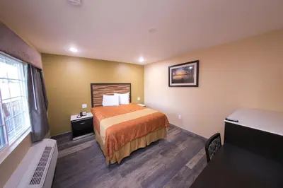 a hotel room with a bed and a window at GAREY MOTEL in Pomona