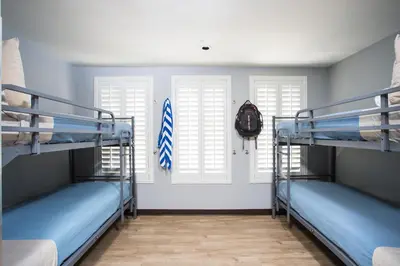 two bunk beds in a room with two windows at HI Los Angeles Santa Monica Hostel in Los Angeles