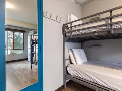 a room with two bunk beds and a hallway at HI Los Angeles Santa Monica Hostel in Los Angeles