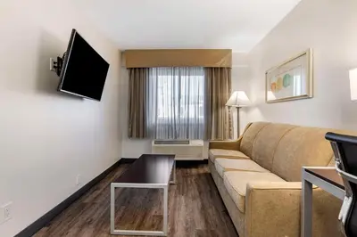 a living room with a couch and a flat screen tv at Quality Inn Burbank Airport in Burbank