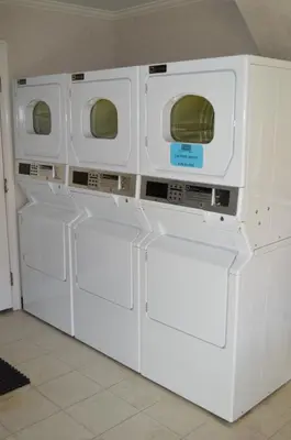 three washing machines are stacked on top of each other at Dynasty Suites Redlands in Redlands