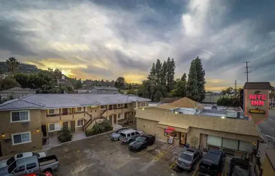 an aerial view of a hotel with cars parked in a parking lot at Nite Inn at Universal City - Walking Distance to Universal Studios Hollywood in Los Angeles