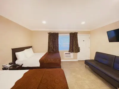 a hotel room with a bed and a couch at Nite Inn at Universal City - Walking Distance to Universal Studios Hollywood in Los Angeles