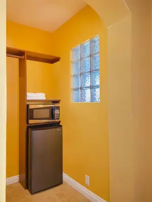 a kitchen with a microwave and a window at El Patio Inn - Near Universal Studios Hollywood in Los Angeles