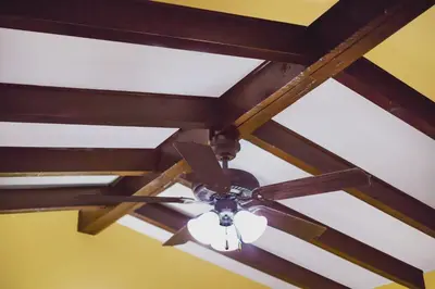 a ceiling fan in a room with wooden beams at El Patio Inn - Near Universal Studios Hollywood in Los Angeles
