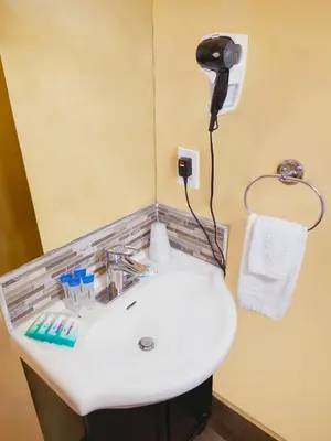 a bathroom with a sink and a phone on the wall at El Patio Inn - Near Universal Studios Hollywood in Los Angeles