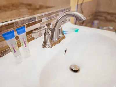 a white sink with two toothbrushes on it at El Patio Inn - Near Universal Studios Hollywood in Los Angeles
