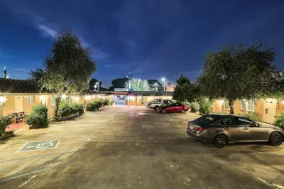 two cars parked in a parking lot at night at El Patio Inn - Near Universal Studios Hollywood in Los Angeles
