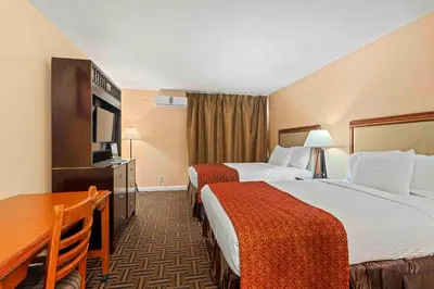 a hotel room with two beds and a desk at The Lemon Tree Hotel in Anaheim
