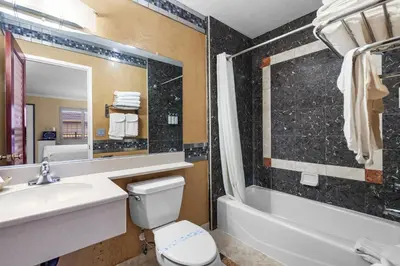 a bathroom with a sink and a toilet and a bath tub at Santa Clarita Motel - Near six Flags Magic Mountain - Valencia in Santa Clarita