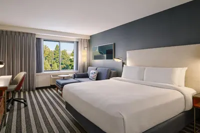 a hotel room with a large bed and a chair at Courtyard Culver City Los Angeles in Los Angeles