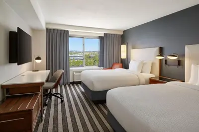 a hotel room with two beds and a desk at Courtyard Culver City Los Angeles in Los Angeles