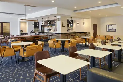 a restaurant with tables and chairs and a bar at Courtyard Culver City Los Angeles in Los Angeles