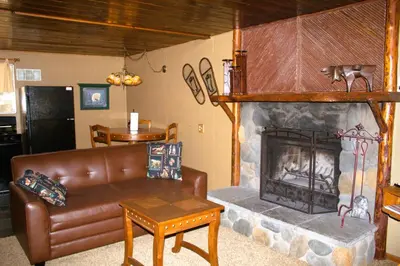 a living room with a couch and a fireplace at Goldmine Lodge in Big Bear Lake