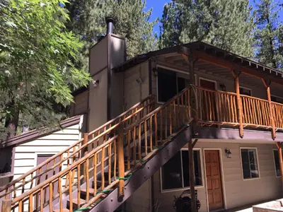 a house with a deck on the side of it at Goldmine Lodge in Big Bear Lake
