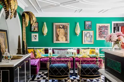 a dining room with purple furniture and green walls at The Prospect Hollywood in Los Angeles