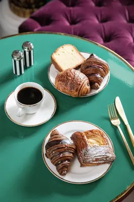a table with two plates of pastries and a cup of coffee at The Prospect Hollywood in Los Angeles