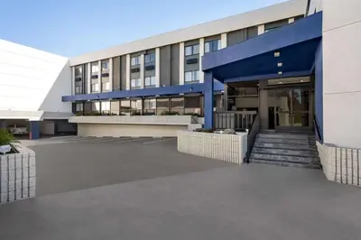 an office building with a blue facade and stairs at Baymont by Wyndham Monterey Park in Monterey Park