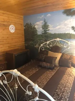 a bed in a room with a painting on the wall at Sequoia National Forest CabinM in Panorama Heights