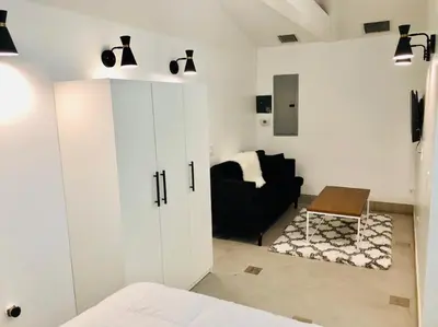 a bedroom with a white cabinet and a chair at Culver City Hostel in Los Angeles