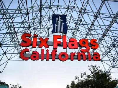 a sign for six flags california hanging from a building at Value Inn in Sylmar