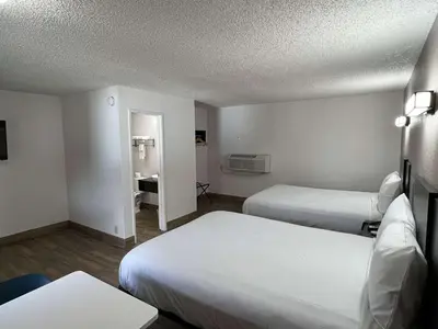 a hotel room with two beds and a mirror at Motel 6-Orange, CA - Anaheim in Anaheim