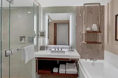 a bathroom with a sink and a tub and a shower at JW Marriott, Anaheim Resort in Anaheim