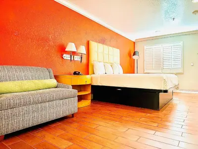 a bedroom with a bed and a couch at Casa Blanca Hotel - Orange in Orange