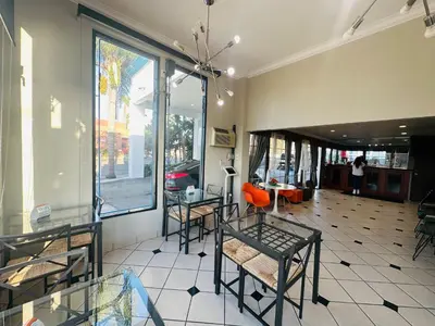 a room with tables and chairs in a building at Casa Blanca Hotel - Orange in Orange