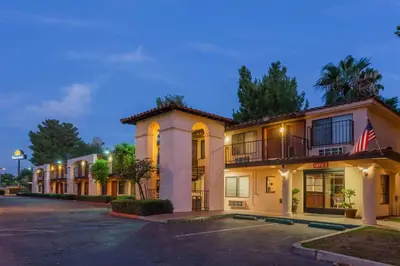 an empty parking lot in front of a hotel at Hospitality Inn in San Bernardino