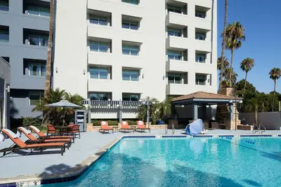 a swimming pool with lounge chairs and a building at Four Points by Sheraton Los Angeles Westside in Los Angeles