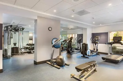 a gym with several treadmills and elliptical machines at Four Points by Sheraton Los Angeles Westside in Los Angeles